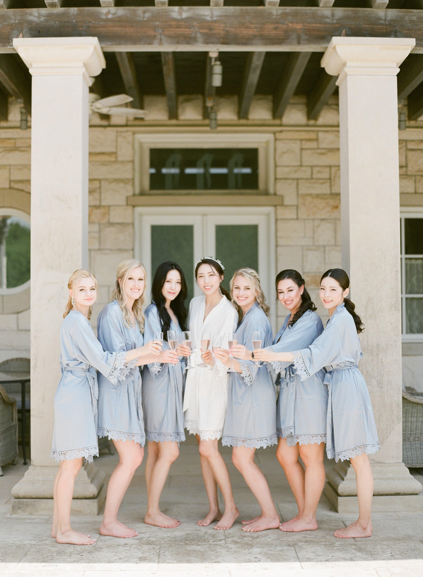 a bride poses with her bridesmaids at the olana