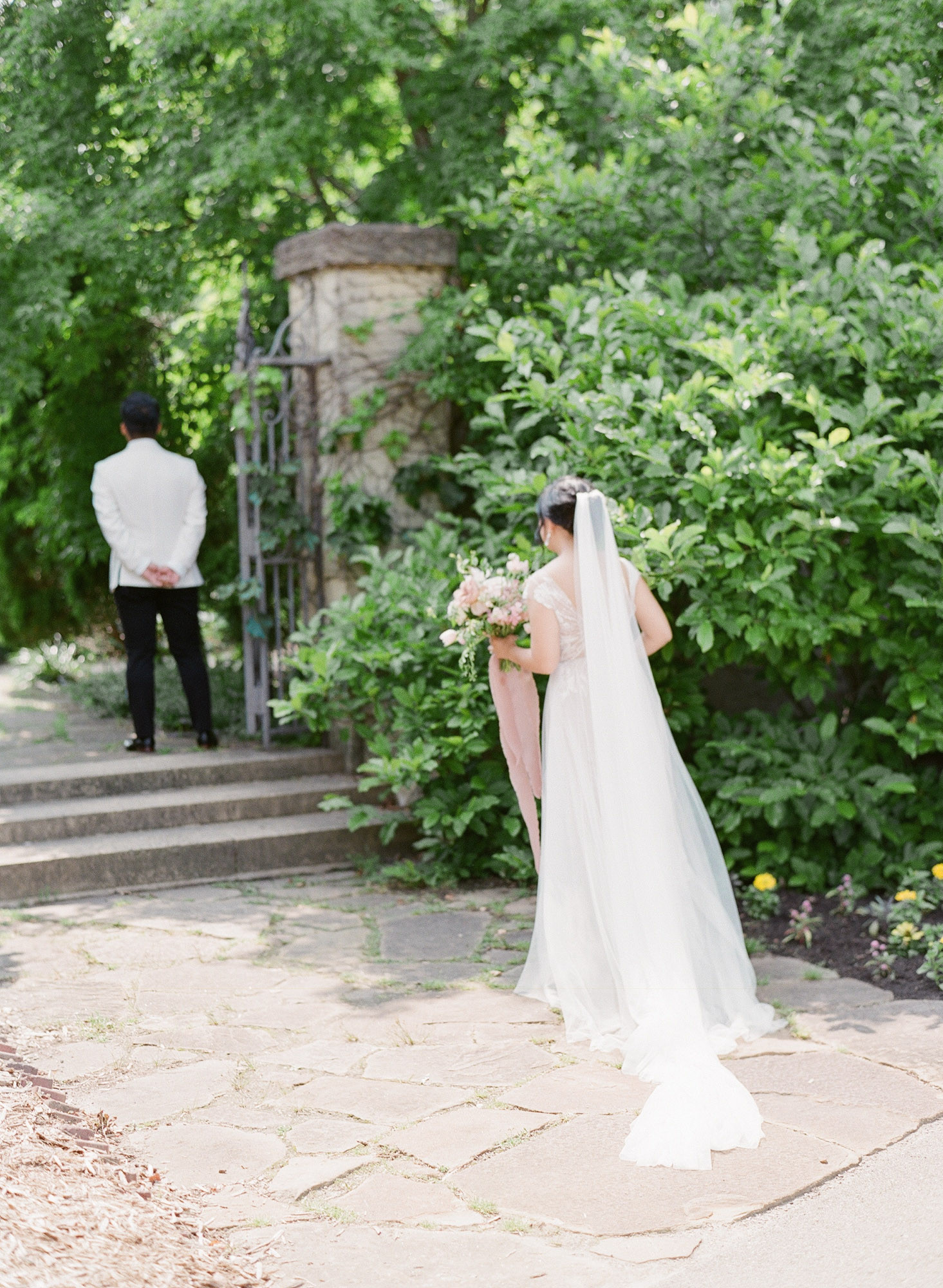 the bride walks up to pray with the groom before the ceremony at the paine art center